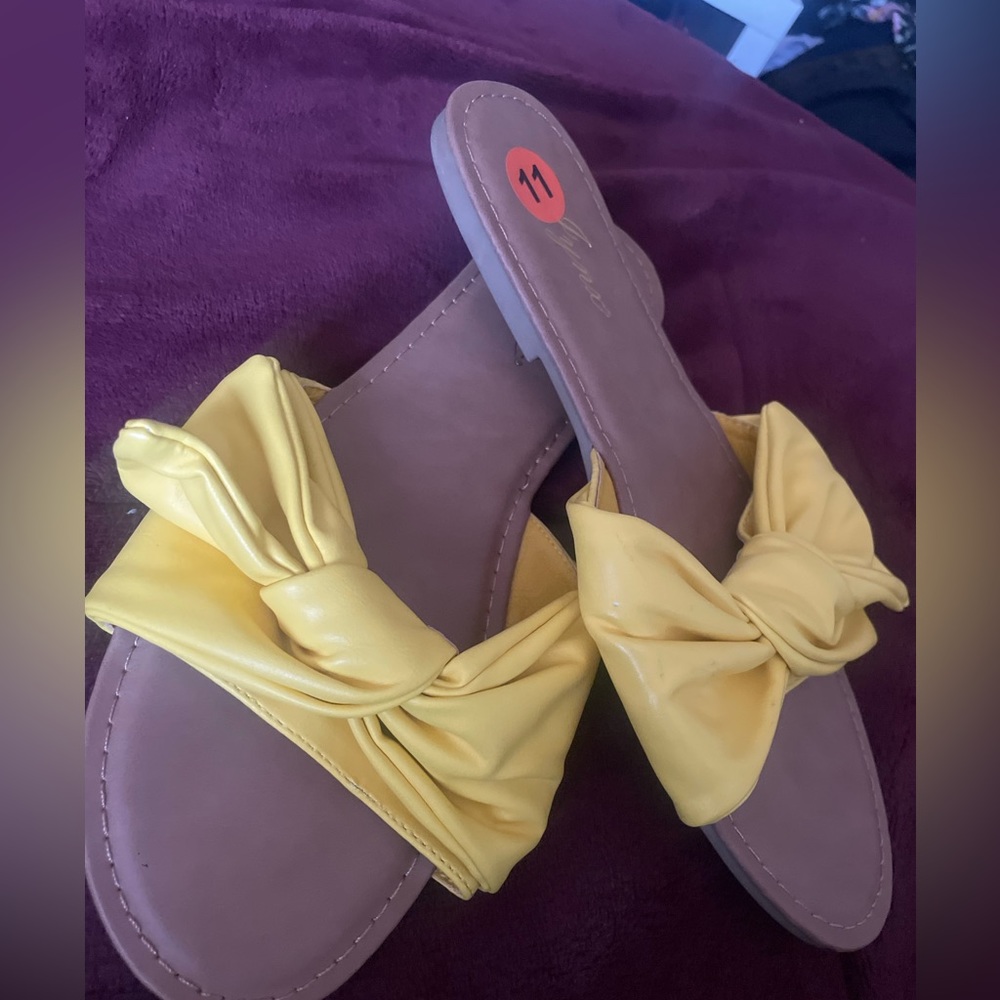 Yellow slide in sandals with bow design. Size 11 brand new.